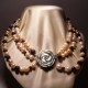 Necklace of three strands of pearls, garnet and mother of pearl closure