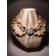 Necklace of three strands of pearls, garnet and mother of pearl closure