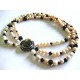 Necklace of three strands of pearls, garnet and mother of pearl closure
